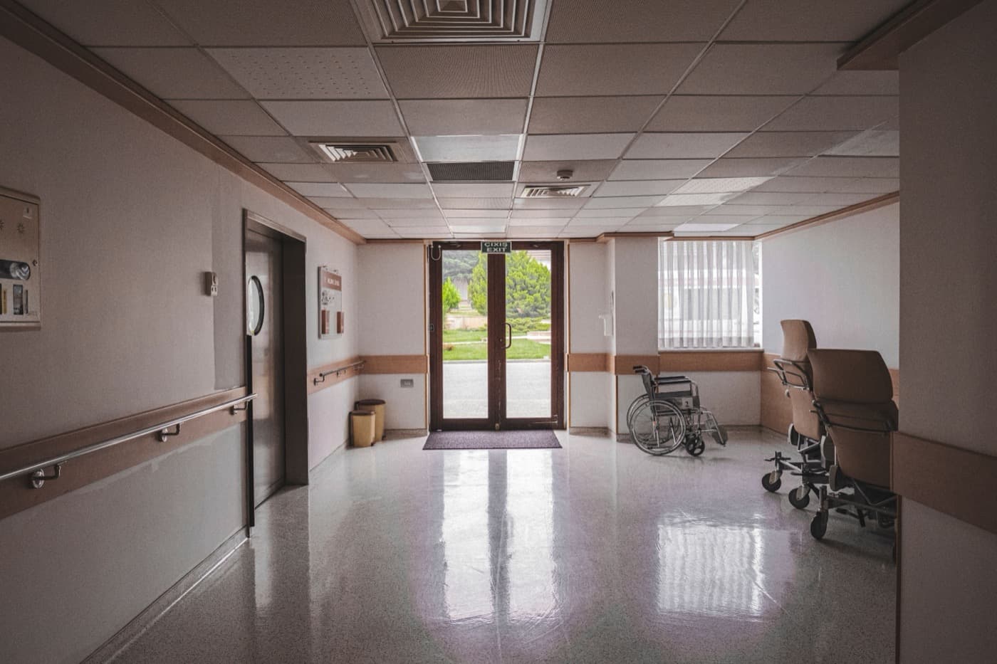 Hospital corridor with wheelchair near glass doors